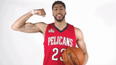 A Pelican 'S Basketball Player Flexes His Muscles While Holding A Spalding Basketball GIF