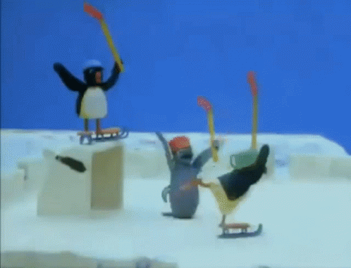 A Penguin Is Holding A Hockey Stick While Another Penguin Is On A Sled . GIF