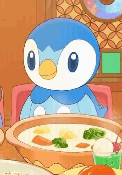 A Penguin Is Sitting At A Table With A Bowl Of Soup And A Cup Of Ice Cream . GIF