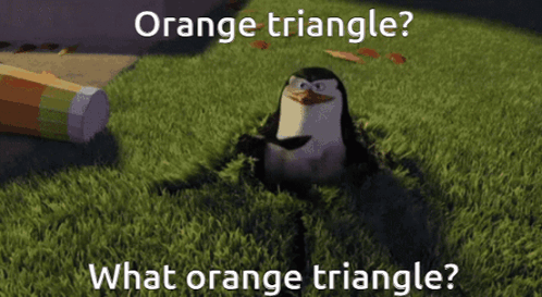 A Penguin Is Sitting In The Grass With The Caption Orange Triangle GIF