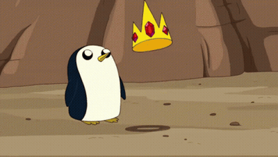 A Penguin Is Standing Next To A Crown With Ruby Stones On It GIF