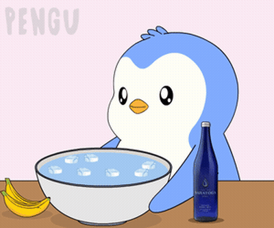 A Penguin Is Taking A Bath In A Bowl Of Water GIF