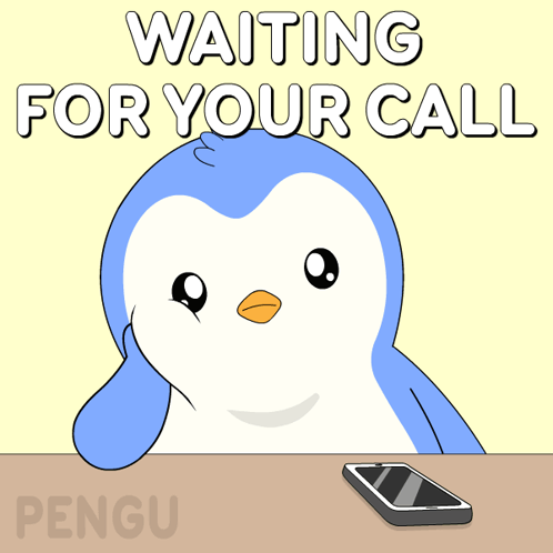 A Penguin Sits At A Table Waiting For A Call With A Cell Phone GIF