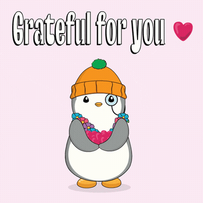 A Penguin Wearing A Beanie And Flowers Around Its Neck Is Grateful For You GIF