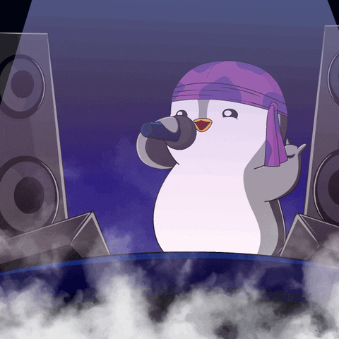 A Penguin Wearing A Purple Bandana Is Singing Into A Microphone In Front Of Speakers GIF