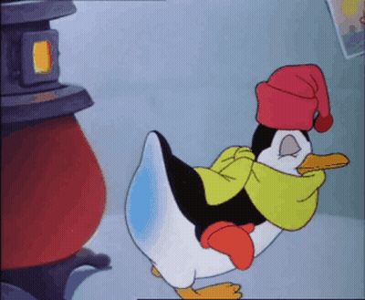 A Penguin Wearing A Red Hat And Scarf GIF