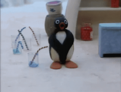 A Penguin With A Straw In Its Mouth Is Standing Next To A Glass Of Water GIF