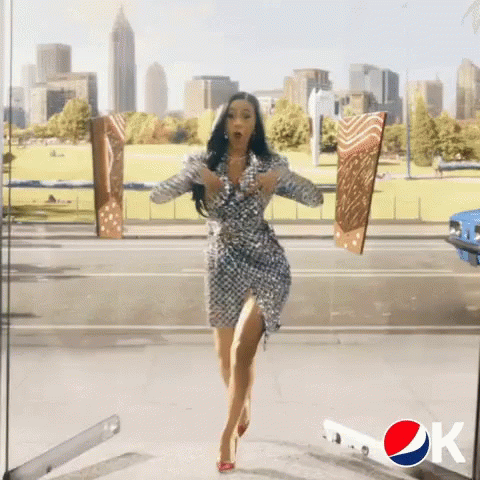 A Pepsi Ad With A Woman In A Dress Running GIF