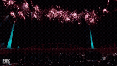 A Pepsi Halftime Show With Fireworks Going Off Behind It GIF