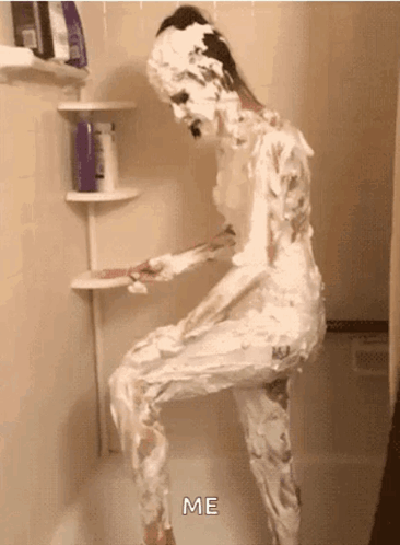 A Person Covered In Shaving Cream Is Standing In A Shower And Saying Me GIF