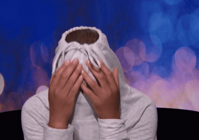 A Person Covering Their Face With A White Sweatshirt GIF