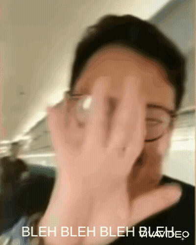 A Person Covering Their Face With Their Hand And The Words Bleh Bleh Bleh Video Below Them GIF