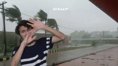 A Person Covering Their Face With Their Hands In Front Of A Sign That Says Hump GIF