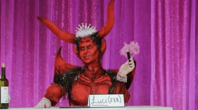 A Person Dressed As A Devil With A Sign That Says Lucifer On It GIF
