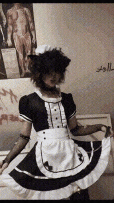 A Person Dressed As A Maid With A Cat Ear Wig GIF