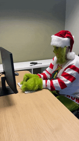 A Person Dressed As The Grinch Is Typing On A Computer Keyboard GIF