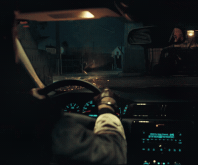 A Person Driving A Car At Night With A Sign That Says ' A ' On The Side GIF