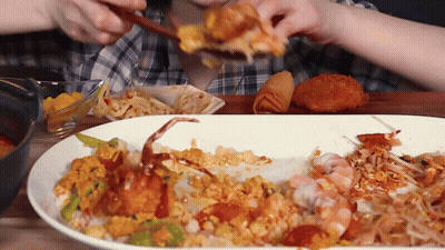 A Person Eating A Plate Of Food With A Crab On It GIF