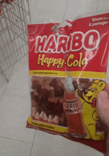 A Person Holding A Bag Of Haribo Happy Cola GIF