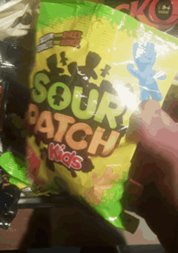 A Person Holding A Bag Of Sour Patch Kids GIF