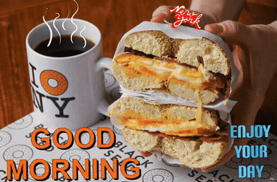 A Person Holding A Bagel Next To A Mug That Says I Love New York GIF