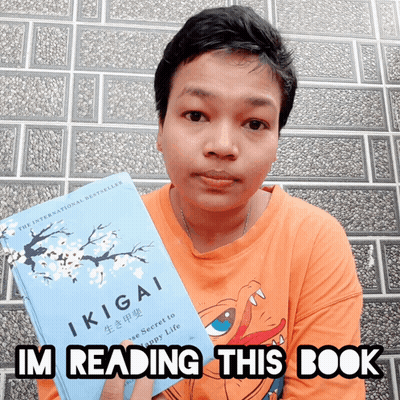 A Person Holding A Book Titled Ikigai And Says I 'M Reading This Book GIF
