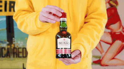 A Person Holding A Bottle Of Beirao In Their Hands GIF