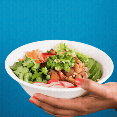 A Person Holding A Bowl Of Food With Vegetables GIF