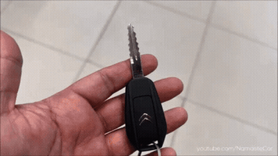 A Person Holding A Car Key In Their Hand GIF