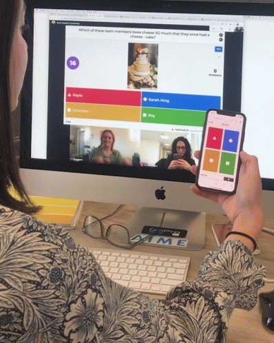 A Person Holding A Cell Phone In Front Of A Computer Screen That Says 16 GIF