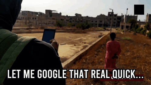 A Person Holding A Cell Phone With The Words " Let Me Google That Real Quick " Below Them GIF