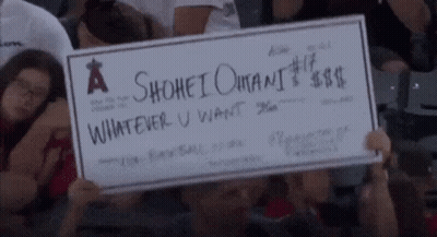 A Person Holding A Check That Says A Shohei Omani Whatever U Want GIF