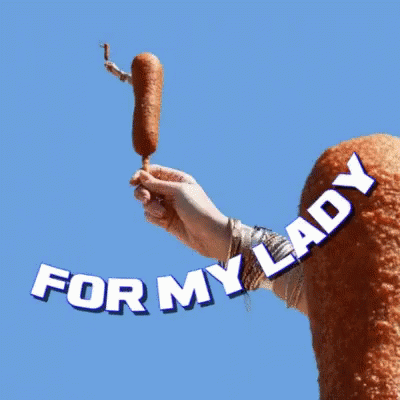 A Person Holding A Corn Dog With The Words " For My Lady " Above Them GIF
