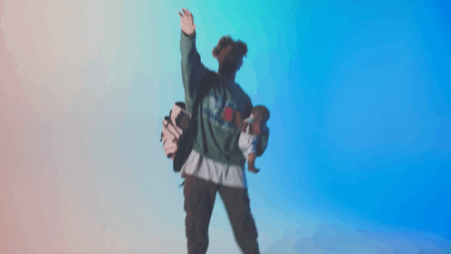 A Person Holding A Doll And A Golf Bag While Wearing A Green Shirt That Says ' Texas ' On It GIF