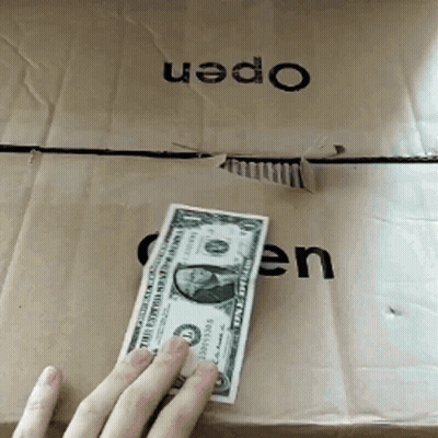A Person Holding A Dollar Bill In Front Of A Box That Says Open GIF