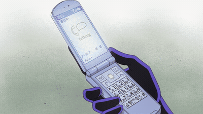 A Person Holding A Flip Phone That Says Talking On It GIF