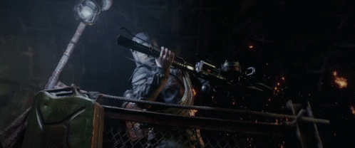 A Person Holding A Gun In A Dark Cave GIF
