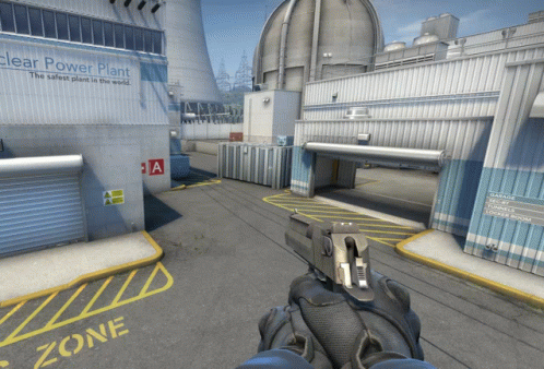 A Person Holding A Gun In Front Of A Nuclear Power Plant GIF
