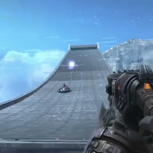 A Person Holding A Gun In Front Of A Ramp With A Car Going Down It GIF
