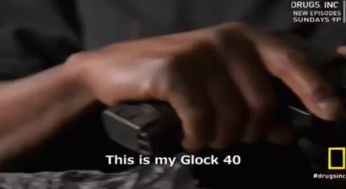 A Person Holding A Gun With The Words " This Is My Glock 40 " On The Bottom GIF