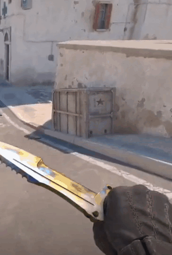 A Person Holding A Knife In Front Of A Building With A Star On It GIF
