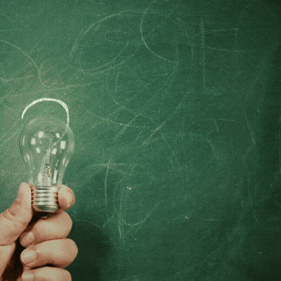 A Person Holding A Light Bulb In Front Of A Chalkboard That Says College On It GIF