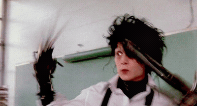 A Person Holding A Pair Of Scissors And A Hammer GIF