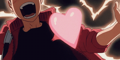 A Person Holding A Pink Heart In Their Hand GIF