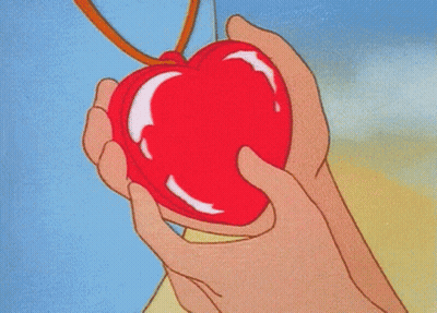A Person Holding A Red Heart Shaped Object GIF