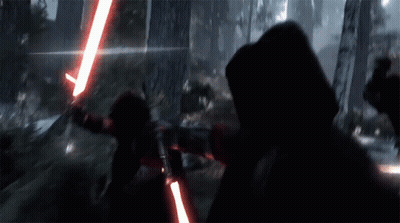 A Person Holding A Red Light Saber In The Dark GIF