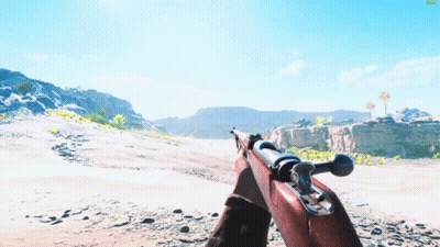 a person holding a rifle in a desert landscape