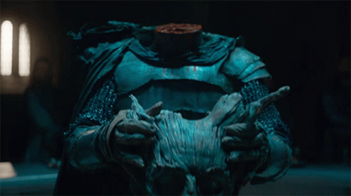 A Person Holding A Statue With A Headless Torso GIF