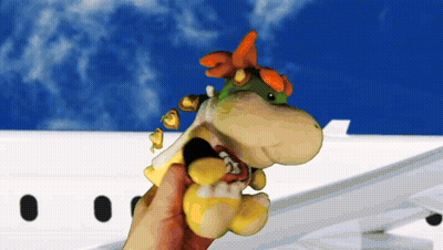 A Person Holding A Stuffed Animal In Front Of A Plane GIF