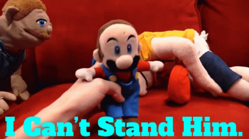 A Person Holding A Stuffed Mario With The Words I Can 'T Stand Him GIF